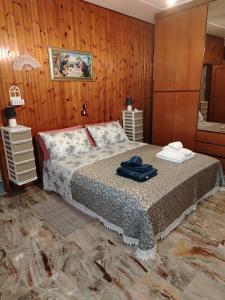 a bedroom with a bed and a wooden wall at Casa della Pace by Pinuccia in Roccaspinalveti