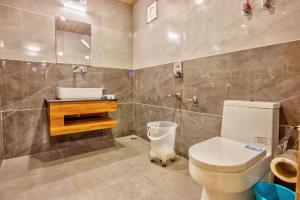 a bathroom with a toilet and a sink at Flora Hills Manali in Jagatsukh +27 photos