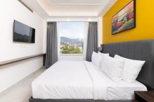 a bedroom with a white bed and a window at Hotel HiStays, Dehradun in Dehradun