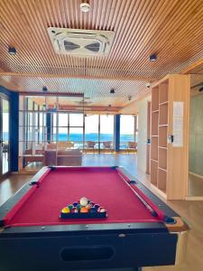 a pool table in a room with a view of the ocean at RARA HM Suites in Hulhumale