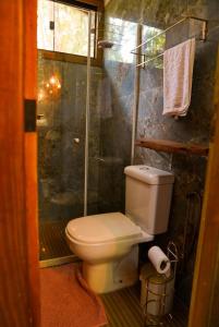 a bathroom with a toilet and a shower at Tree House in Vítor Hugo