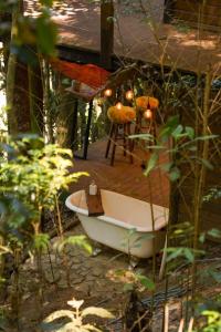 a bath tub sitting on top of a deck at Tree House in Vítor Hugo +2 photos