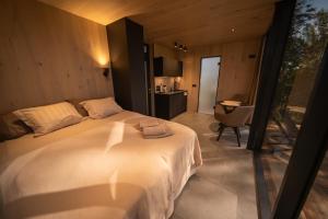 a bedroom with a large white bed and a desk at Escape - Bollnäs in Bollnäs