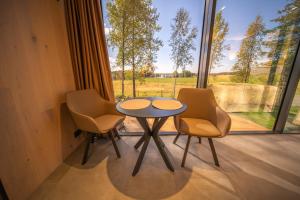 a table and two chairs in a room with a window at Escape - Bollnäs in Bollnäs
