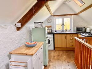 a kitchen with a green refrigerator and a stove at Little Barn, Greendale Farm in Barnstaple