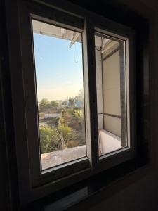 a window in a room with a view at Sunrise stay in Mathura