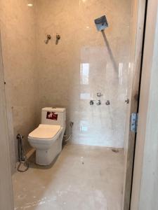 a bathroom being remodeled with a toilet and a shower at Sunrise stay in Mathura