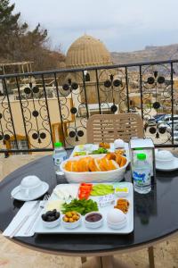 a table with a tray of food on a balcony at The Castle İnn in Mardin