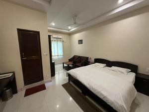 a bedroom with a bed and a chair in it at Hotel Meghdoot in Bhadohī +14 photos