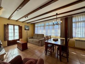 a living room with a table and a couch at Casas Rurales Las Corradas in Éndriga