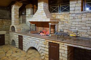 a stone oven with a fire inside of it at Epavlis Nadine Corfu in Corfu