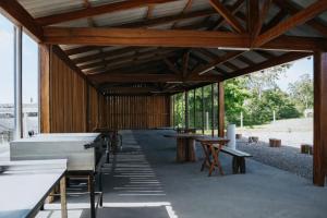 a large wooden building with tables and benches at DE STEFANI HOTEL in Portão