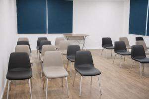 an empty room with chairs and a table in it at DE STEFANI HOTEL in Portão