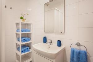 a white bathroom with a sink and a mirror at Casa de Baixo in Odeceixe +16 photos