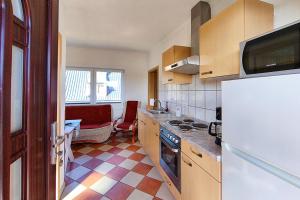 a kitchen with a refrigerator and a stove top oven at Ferienwohnung Sonnenblick in Loddin