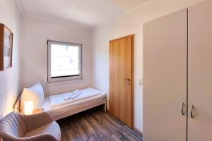 a small room with a couch and a window at Ferienwohnung Sonnenblick in Loddin
