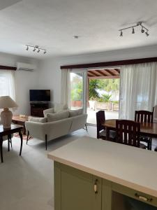 a living room with a couch and a table at Beach House With Direct Access to Private Beach Near Bodrum in Çamlık