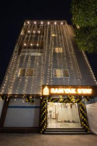 a building with lights on the side of it at Samyak Stay in Ujjain