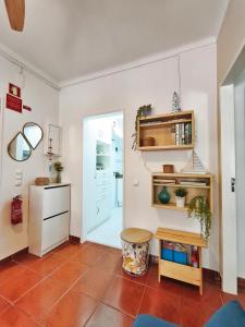 a living room with a table and a door at Sesimbra Fé House in Sesimbra +18 photos