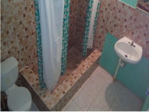 a bathroom with a sink and a toilet at Room With Queen Size Bed in Falmouth