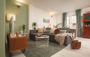 a living room with a couch and a tv at Madau's House Exclusive Apartments in Olbia