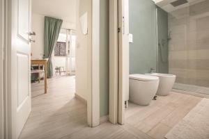 a bathroom with a toilet and a shower at Madau's House Exclusive Apartments in Olbia +48 photos