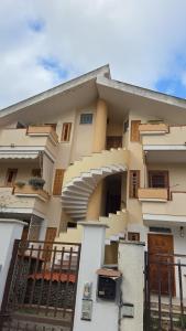 a building with stairs and a fence in front of it at Ampia terrazza privata a due passi da Pizzo e Tropea in Vibo Valentia Marina