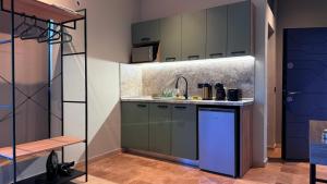 a kitchen with green cabinets and a sink at Olea Apartments in Potos +24 photos