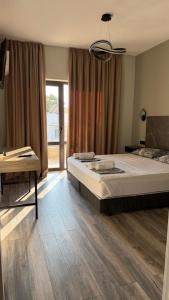 a bedroom with a large bed and a table at Olea Apartments in Potos