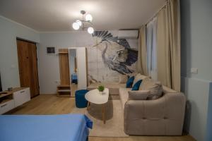 a living room with a couch and a bird mural at Ramonda Riverside in Veliko Gradište