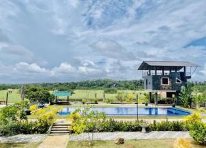 a villa with a swimming pool and a building at The Lark Resort ,induruwa in Induruwa