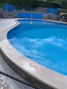 a large swimming pool with blue water at Blumoon Capri con accesso Piscina in Anacapri +51 photos
