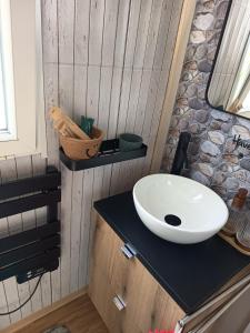 a bathroom with a white sink on a counter at Mobile home in Quimper +14 photos