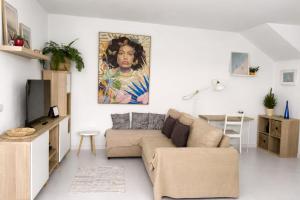 a living room with a couch and a painting on the wall at El Timón in La Santa