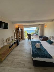 a bedroom with two beds and a view of the ocean at "Cap Riviera" Hotel & Restaurant Saint Aygulf in Saint-Aygulf
