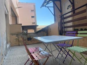 a table and two chairs sitting on a balcony at La Parenthèse de Foch in Le Puy-en-Velay