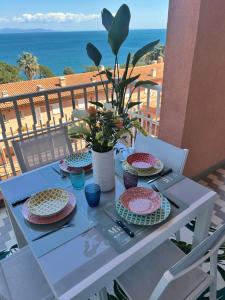 a table with plates and bowls on top of a balcony at Marina Elite Capo D'Arco in Capo D'Arco
