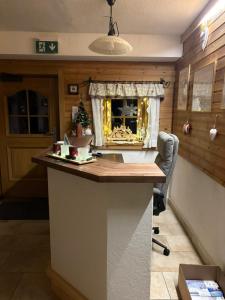 a kitchen with a counter with a christmas tree in a window at Rössingerhof in Ramsau am Dachstein +62 photos