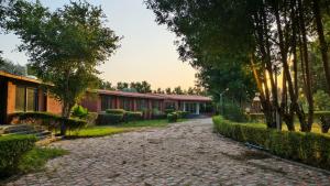 a cobblestone street in front of a building at Nal Village Resort By Explore With Nirav in Rupāwati