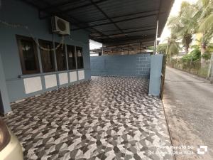 a building with a tile floor next to a street at 51 SpS HOMES in Bagan Serai