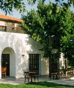 a group of tables and chairs in front of a building at Riserva Urla in Urla