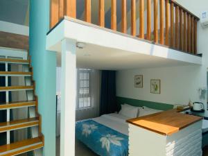 a bedroom with a bunk bed and a staircase at 叁三民宿 in Dali