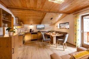 a kitchen and dining room with a table and chairs at Bauernhof Klausbauer in Grossarl