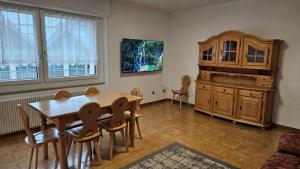 a dining room with a wooden table and chairs at Appartamenti Croz del Re 2 in Andalo