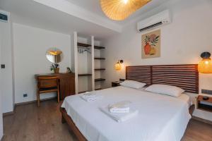 a bedroom with a large white bed and a desk at Riserva Urla in Urla