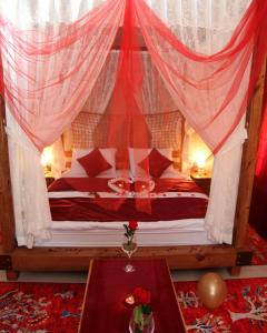 a bedroom with a canopy bed with a table at Karballa Hotel in Aksaray +44 photos