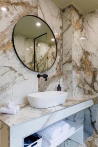 a bathroom with a sink and a mirror at Angels Riva Boutique Residences in Kastoria +37 photos