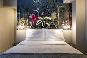 a bedroom with a bed with a floral wallpaper at Angels Riva Boutique Residences in Kastoria