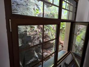 a view from a window of a mountain view at Albergue Val de Samos in Samos