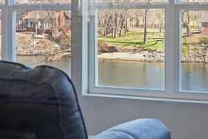 a room with two windows with a view of a river at Waterfront Condo near Marina in Branson